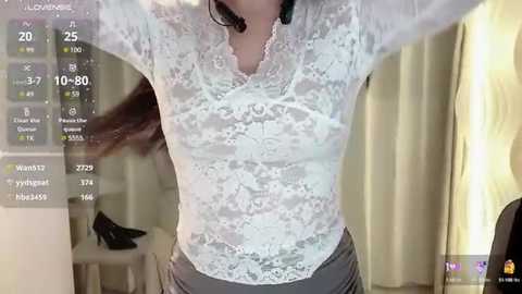 Media: A video of a woman wearing a white lace blouse, showing cleavage, with a digital display showing temperature, humidity, and wind speed in the background.