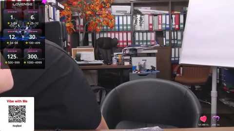 Media: A video of an office interior with a woman in a black shirt facing a computer screen displaying a virtual reality application.