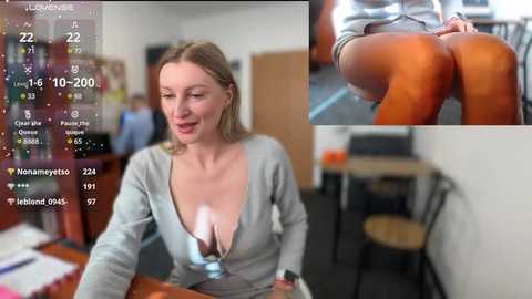 Media: Video of a blonde woman in a low-cut top, sitting at a desk, with a close-up of her legs in a second image. Background shows a cluttered office.