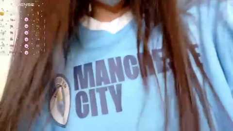 Media: Video of a person wearing a light blue Manchester City soccer jersey with a white emblem and the team's name in bold letters.