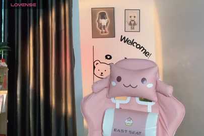 Media: Video of a pastel pink Minecraft-themed gaming chair with a \"Welcome!\" sign and two framed pictures in the background, featuring a teddy bear and Minecraft character.