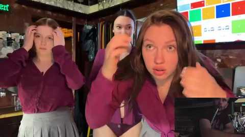 Media: Video of three young women in a bar, two in maroon tops, one in a blue blouse, all looking startled, with a TV screen displaying colorful graphics in the background.