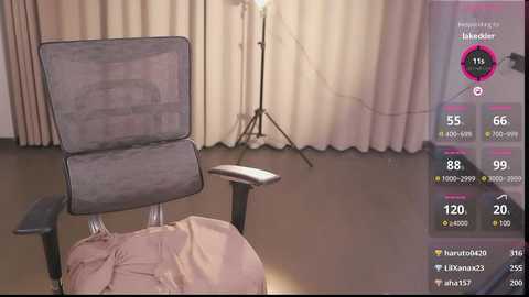 Media: A video depicts a cozy room with beige curtains, a chair with a grey cushion, and a lamp on a tripod, with a digital overlay showing live stream stats.