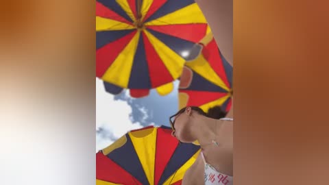 Media: Video of a woman with short brown hair, wearing sunglasses and a white top, holding a large, multi-colored beach umbrella with yellow, red, and blue stripes against a blue sky.