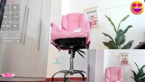 Media: Video of a pink baby chair on a metal stand in a modern, minimalist nursery with a white wall, a potted plant, and a poster.