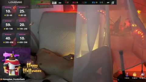 Media: Video of a woman in a white, sheer nightgown with a slit, lying on a bed. The room is dimly lit with red and orange hues, creating a sensual atmosphere.