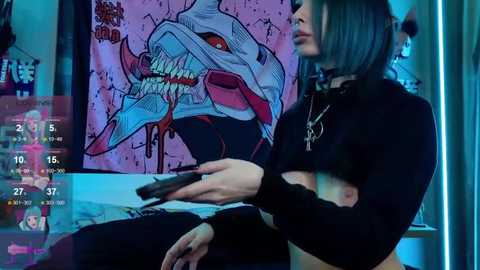 Media: Video of a woman with dark hair, wearing a black crop top and choker, holding a black gun. Background features a large, colorful, stylized monster illustration and a virtual reality interface.