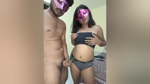 Media: Video of a nude man with a circumcised penis and a woman with a black bandeau and striped panties in a bedroom.