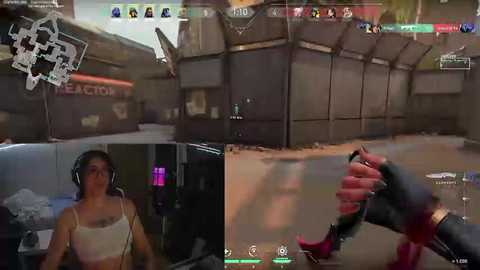 Media: Video collage of a video game scene from \"Overwatch\" featuring two characters: a woman with brown hair in a white tank top, and a red and black-clad man holding a pistol.