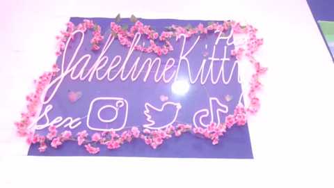 Media: Video of a heart-shaped sign with \"YakelimeKitten\" written in elegant cursive, surrounded by pink cherry blossoms, against a purple background.