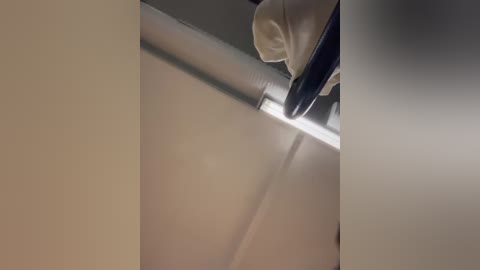 Media: A video of a person using a screwdriver to install a white ceiling panel, capturing the moment with a tight focus on the screwdriver and panel.