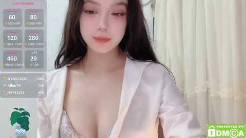 Media: Video of an East Asian woman with long black hair, wearing a white blouse exposing cleavage, in a bathroom setting.