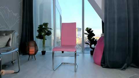 Media: Video of a modern, minimalist living room with a pink chair, potted plants, a white couch, and large windows overlooking a city skyline.