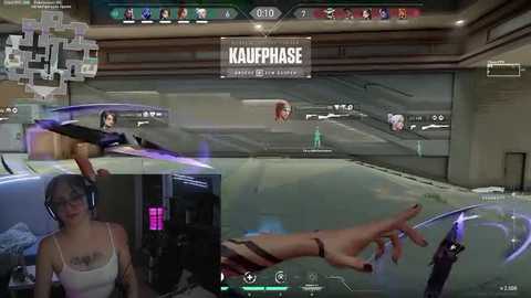 Media: Video of a virtual reality game featuring a woman with glasses and headphones, playing \"Kaufphase\" in a futuristic setting with high-tech interfaces and a floating hand.