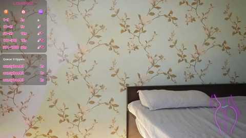 Media: A video of a modern bedroom with a light blue and white floral wallpaper, a dark wood headboard, and a neatly made bed with white linens.