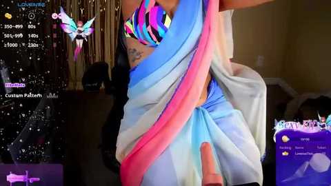 Media: Video of a person in a colorful, multicolored saree with a large, erect penis visible, set in a nightclub with virtual reality overlays of stats and a butterfly avatar.