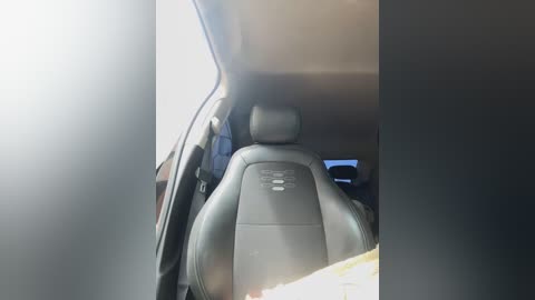 Media: Video of a car interior showing a black leather seat with a headrest, a sunroof, and a partially visible steering wheel.