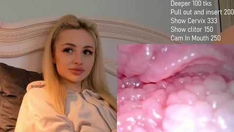 Media: Video of a blonde woman with fair skin, wearing a beige jacket, sitting on a bed with dark brown sheets. Close-up of a pinkish vaginal canal with clear fluid, next to text details of her \"Deep Throat\" video.