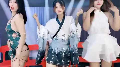 Media: Video of three young Asian women, in traditional and modern attire, dancing with joyful expressions.