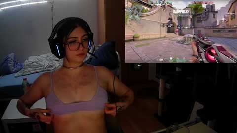 Media: Video collage featuring a woman with glasses and headphones adjusting a purple bra, surrounded by a dimly lit room; an in-game screenshot of a woman with similar features in a virtual reality game.