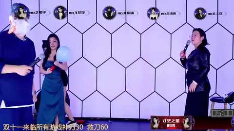 Media: Video of three people singing karaoke in a futuristic, hexagonal-patterned room. One person in a green apron holds a balloon, another in a black jacket sings, and the third holds a microphone.