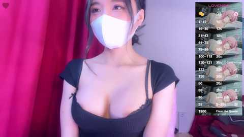 Media: A video of an Asian woman in a black top, wearing a mask, with a video overlay of a game showing her character's stats and inventory.