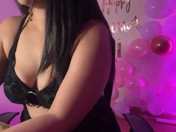 Media: Video of a curvaceous woman with long black hair, wearing a black lace bra, in a dimly lit room with pink and purple balloons.