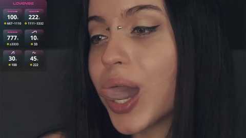 Media: Video of a close-up of a woman with long black hair, light skin, and black eyeliner, wearing a nose piercing. Background includes a digital health tracking display showing heart rate, steps, and sleep data.