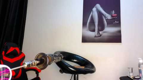 Media: A video of a woman reclining on a black leather chair in a dimly lit room, with a tattoo sleeve visible, and a wall-mounted painting of a nude woman in the background.