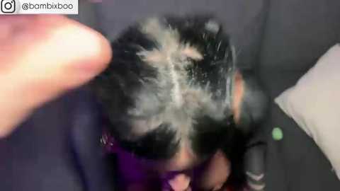 Media: Video of a person with black hair, wearing a dark coat, with a large white substance, possibly shaving cream, covering their head. The background is indistinct, with a watermark \"bamboo\" in the top left corner.