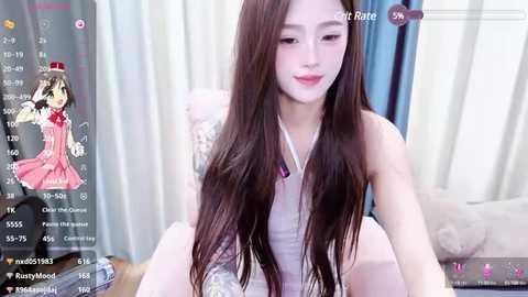 Media: Video of an East Asian woman with long brown hair, fair skin, and wearing a white sleeveless dress, sitting on a bed with white curtains and a pillow in the background.