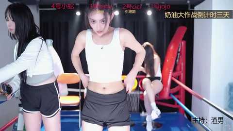 Media: Video of a young, muscular Asian woman in a white sports bra and black shorts, mid-routine, in a brightly lit gym with red and yellow equipment and Chinese text in the background.