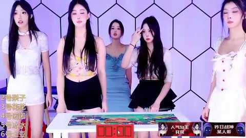 Media: A video of four Asian women, dressed in colorful, tight-fitting outfits, standing in front of a pool table with a red and green ball, in a modern, hexagonal-patterned room.