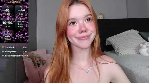 Media: Video of a smiling, fair-skinned, red-haired woman in a bedroom, wearing a silver necklace, with a \"Temptation Island\" TV show screen overlay.