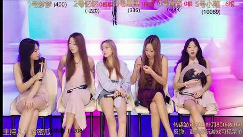 Media: Video of five Asian women, seated on a stage, dressed in casual summer outfits, each holding a microphone, engaging in a lively discussion against a colorful, abstract background.