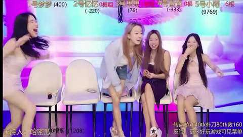 Media: Video of four young Asian women, laughing and clapping, seated on modern white chairs, in a colorful, illuminated studio setting, with vibrant stage lights and Chinese text onscreen.