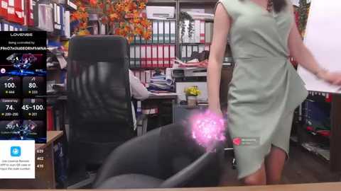 Media: A video captures a woman in a light green dress standing in an office with a black chair, autumn leaves, and various office supplies. A virtual avatar floats beside her.