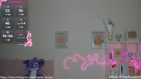 Media: A video of a pink-themed room with a plush toy, a neon sign, and framed art on a white wall.