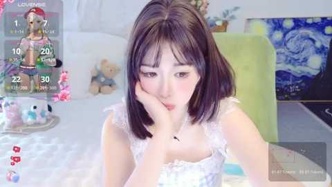 Media: A video of an Asian woman with straight black hair, wearing a white lace bra, sitting on a bed, with a virtual reality headset on, displaying a virtual reality scene.