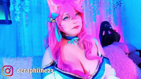 Media: Video of a woman in a revealing blue and white cosplay costume with pink hair, large breasts, and cat ears, against a neon blue and purple background.