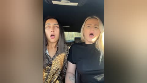 Media: Video of two people in a car, a young Asian man with long black hair and a blonde woman, both laughing with open mouths.