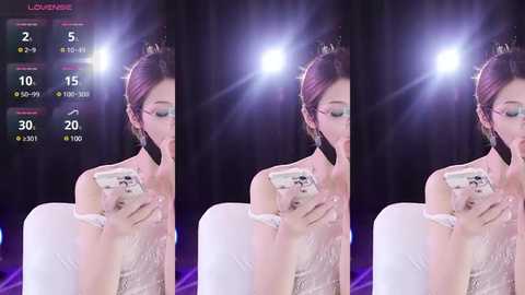 Media: A video of a young woman with fair skin and brown hair, wearing a white lace dress, sitting on a white couch. She's holding a smartphone, looking at it with a serene expression. The background is dark with soft lighting, and a digital clock overlay displays time.