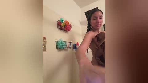 Media: A video of a naked woman with wet hair, standing in a shower, holding a phone to take a mirror selfie.