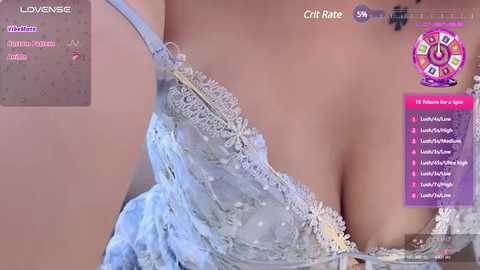 Media: Video of a woman's bare chest in a light blue lace bra, showing cleavage, with a virtual \"love meter\" overlay.