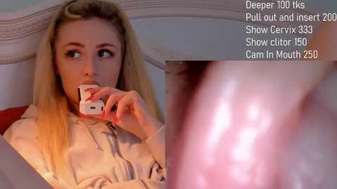 Media: A video featuring a blonde woman with long hair, wearing a beige blouse, holding a phone to her mouth, with a close-up of a cervix in the background.