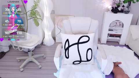 Media: A video of a stylish white armchair with a black \"L\" pillow, surrounded by modern white furniture, a purple gaming overlay, and a fluffy white rug.