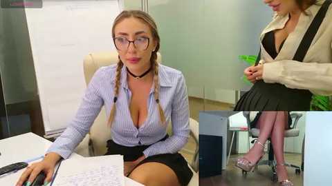 Media: Video of a blonde woman in glasses, unbuttoned blue and white striped blouse, sitting at a desk, holding papers, office background.