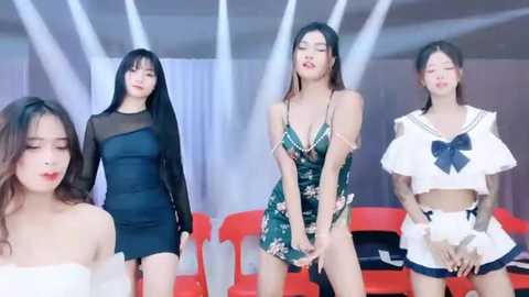 Media: Video of four Asian women in provocative outfits; one in a sheer black dress, another in a floral green dress, third in a sailor outfit, and last in a black mini-skirt.