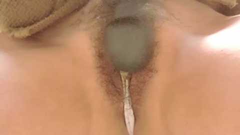 Media: Video of a close-up, zoomed-in view of a human vulva, with pubic hair, visible labia, and a zipper-like appearance, likely due to a medical condition.