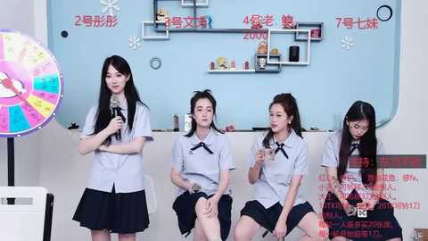 Media: Video of four young Asian women in school uniforms, singing and holding microphones, against a light blue wall with Chinese text and toys.